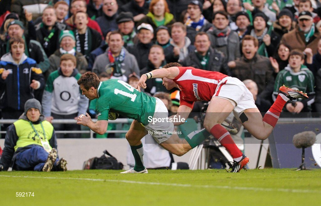 5 February 2012; Tommy Bowe, Ireland, on his way to scoring his side's second try, despite the attention of George North, Wales. RBS Six Nations Rugby Championship, Ireland v Wales, Aviva Stadium, Lansdowne Road, Dublin. Picture credit: Brian Lawless / SPORTSFILE