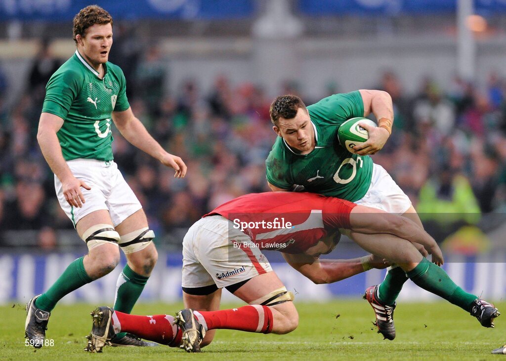 5 February 2012; Cian Healy, Ireland, with support from team mate Donnacha Ryan, is tackled by Ian Evans, Wales. RBS Six Nations Rugby Championship, Ireland v Wales, Aviva Stadium, Lansdowne Road, Dublin. Picture credit: Brian Lawless / SPORTSFILE