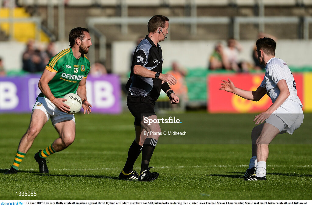 17 June 2017; Graham Reilly of Meath in action against David Hyland of Kildare as referee Joe McQuillan looks on during the Leinster GAA Football Senior Championship Semi-Final match between Meath and Kildare at Bord na Móna O'Connor Park in Tullamore, Co Offaly. Photo by Piaras Ó Mídheach/Sportsfile