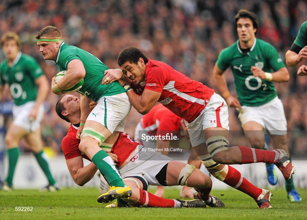 5 February 2012; Jamie Heaslip, Ireland, is tackled by Ian Evans, left, and Toby Faletau, Wales. RBS Six Nations Rugby Championship, Ireland v Wales, Aviva Stadium, Lansdowne Road, Dublin. Picture credit: Stephen McCarthy / SPORTSFILE