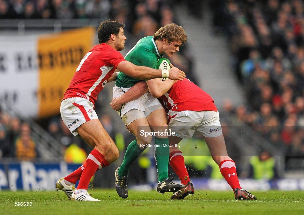 5 February 2012; Andrew Trimble, Ireland, is tackled by Mike Phillips, left, and Rhys Gill, Wales. RBS Six Nations Rugby Championship, Ireland v Wales, Aviva Stadium, Lansdowne Road, Dublin. Picture credit: Stephen McCarthy / SPORTSFILE