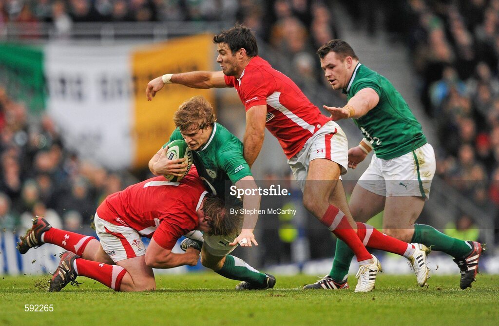 5 February 2012; Andrew Trimble, Ireland, with support from team mate Cian Healy, is tackled by Mike Phillips, left, and Rhys Gill, Wales. RBS Six Nations Rugby Championship, Ireland v Wales, Aviva Stadium, Lansdowne Road, Dublin. Picture credit: Stephen McCarthy / SPORTSFILE