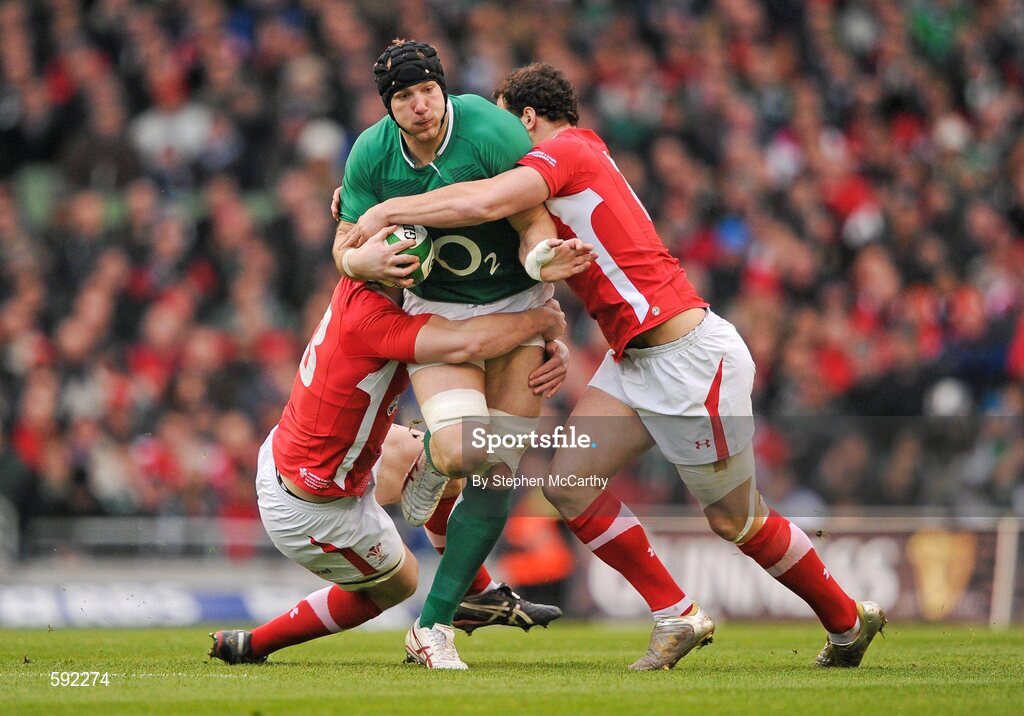 5 February 2012; Stephen Ferris, Ireland, is tackled by Jonathan Davies and Jamie Roberts, right, Wales. RBS Six Nations Rugby Championship, Ireland v Wales, Aviva Stadium, Lansdowne Road, Dublin. Picture credit: Stephen McCarthy / SPORTSFILE