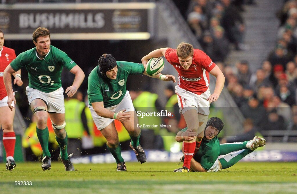 5 February 2012; Rhys Priestland, Wales, escapes the tackle of Mike Ross and Stephen Ferris, Ireland. RBS Six Nations Rugby Championship, Ireland v Wales, Aviva Stadium, Lansdowne Road, Dublin. Picture credit: Brendan Moran / SPORTSFILE