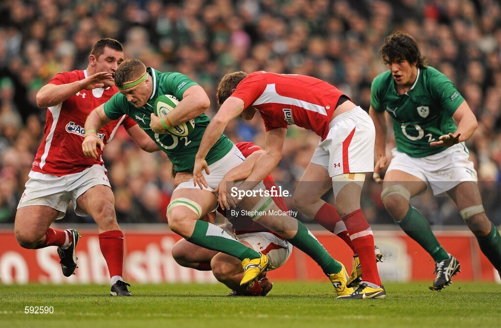 5 February 2012; Jamie Heaslip, Ireland, with support from Donncha O'Callaghan is tackled by Wales players, from left, Huw Bennett, Rhys Gill and Rhys Priestland. RBS Six Nations Rugby Championship, Ireland v Wales, Aviva Stadium, Lansdowne Road, Dublin. Picture credit: Stephen McCarthy / SPORTSFILE