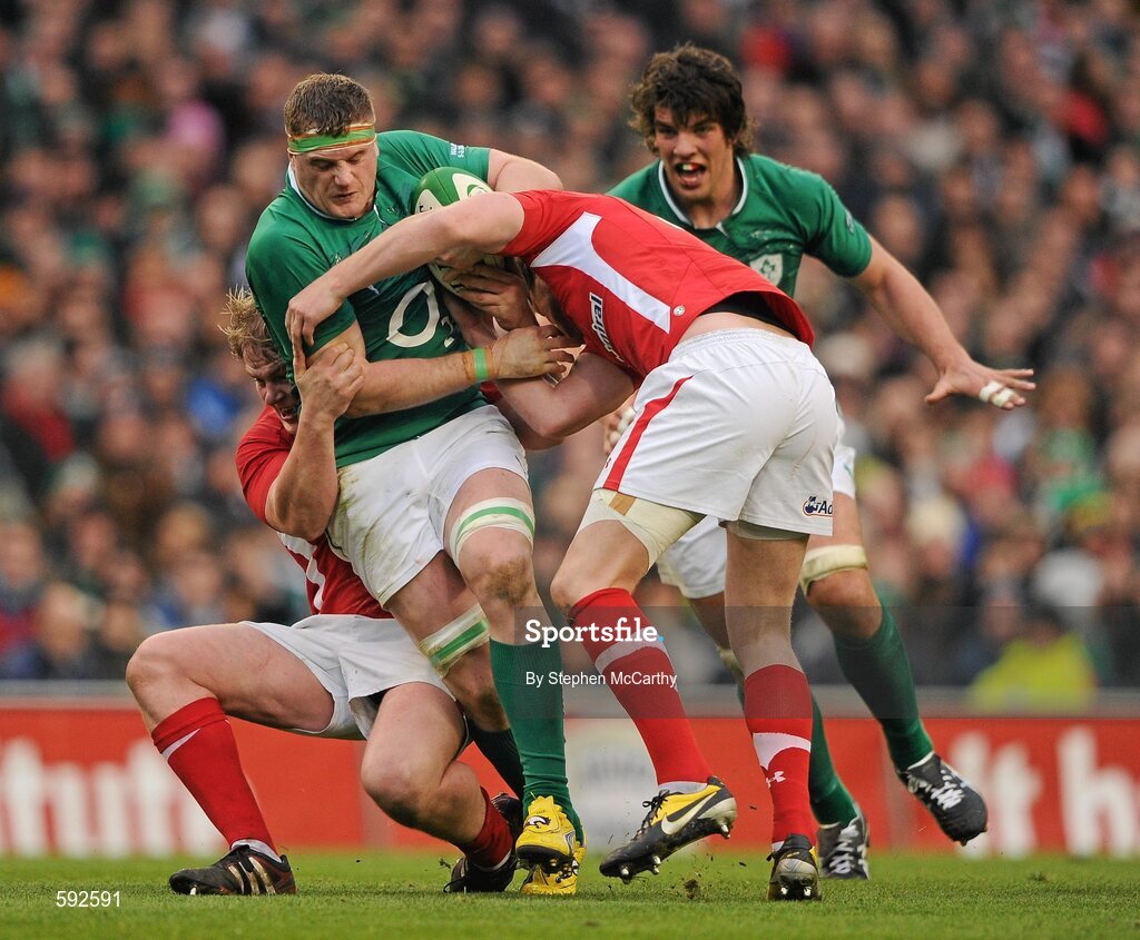 5 February 2012; Jamie Heaslip, Ireland, with support from Donncha O'Callaghan is tackled by Wales players Rhys Gill and Rhys Priestland, right. RBS Six Nations Rugby Championship, Ireland v Wales, Aviva Stadium, Lansdowne Road, Dublin. Picture credit: Stephen McCarthy / SPORTSFILE