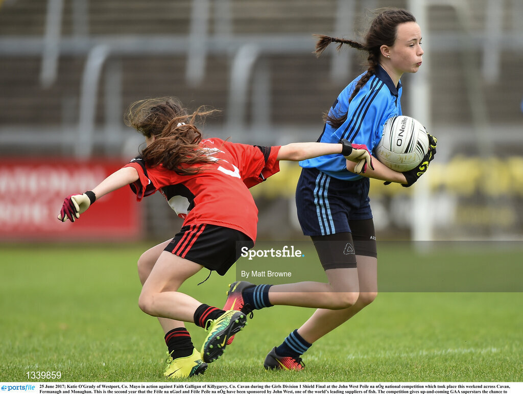 25 June 2017; Katie O'Grady of Westport, Co. Mayo in action against Faith Galligan of Killygarry, Co. Cavan during the Girls Division 1 Shield Final at the John West Peile na nÓg national competition which took place this weekend across Cavan, Fermanagh and Monaghan. This is the second year that the Féile na nGael and Féile Peile na nÓg have been sponsored by John West, one of the world’s leading suppliers of fish. The competition gives up-and-coming GAA superstars the chance to participate and play in their respective Féile tournament, at a level which suits their age, skills and strengths.   Photo by Matt Browne/Sportsfile