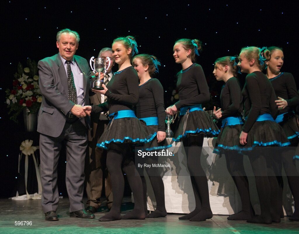 18 February 2012; The Crecora GAA Club, Co. Limerick, team of Aisling Coughlin, Orla Byrnes, Olive Wixsted, Eimear Mahon, Caoimhe Sheehan, Amy O'Connor, Fiona Hogan, and Emer Kennedy, arrive to collect the cup and medals from Paddy Naughton, Cathaoirleach, Comhairle Connacht, and Des Maguire, Cathaoirleach, Coiste Scór Naisúnta, after winning the 'Figure Dancing' competition during the All-Ireland Scór na nÓg Final 2012. Royal Theatre & Events Centre, Castlebar, Co. Mayo. Picture credit: Ray McManus / SPORTSFILE