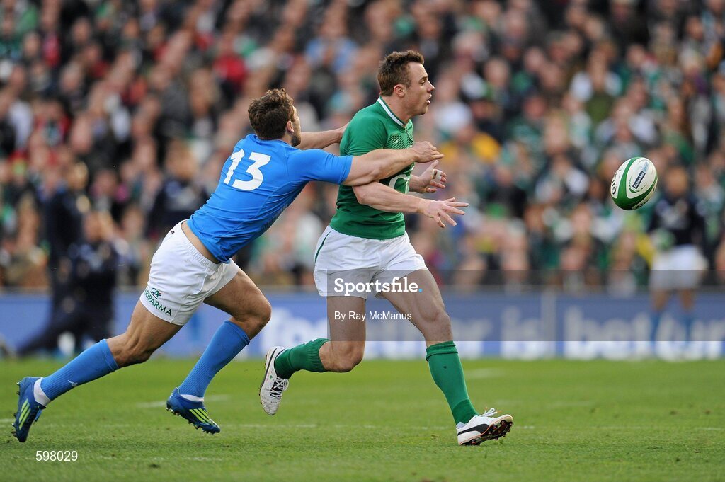 25 February 2012; Tommy Bowe, Ireland, gets his pass away despite the tackle of Tommaso Benvenuti, Italy. RBS Six Nations Rugby Championship, Ireland v Italy, Aviva Stadium, Lansdowne Road, Dublin. Picture credit: Ray McManus / SPORTSFILE