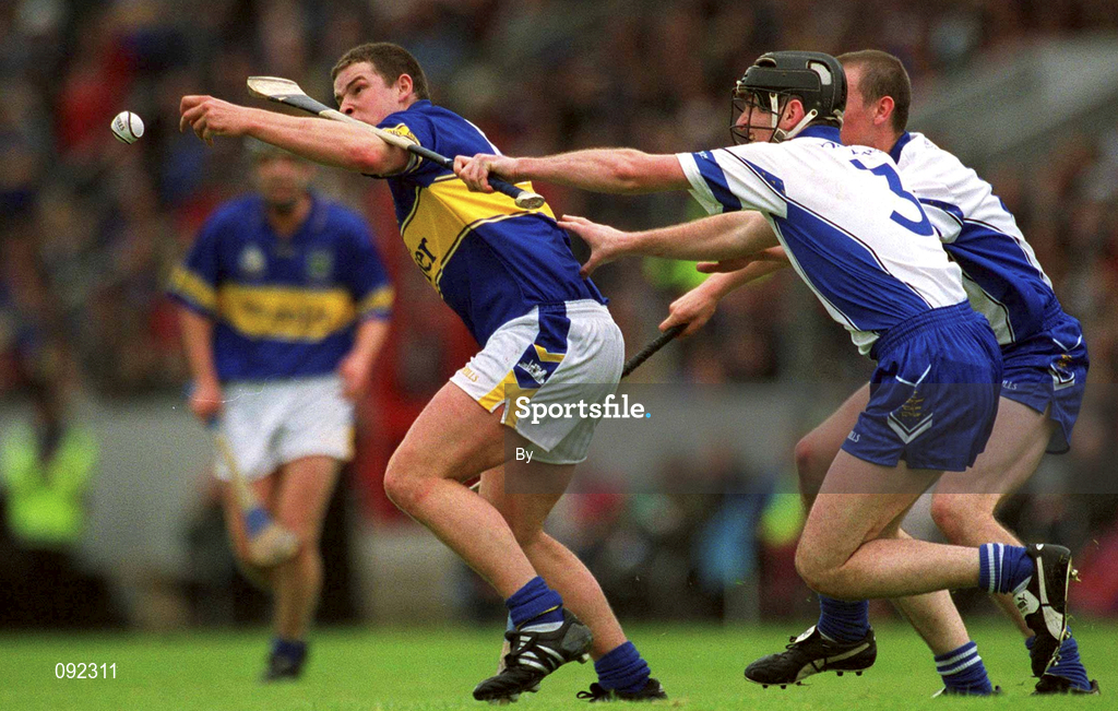 30 June 2002; John Carroll, Tipperary, in action against Waterford's Tom Feeney. Waterford v Tipperary, Guinness Munster Hurling Final, Pairc Ui Chaoimh, Cork. Picture credit; Ray McManus / SPORTSFILE