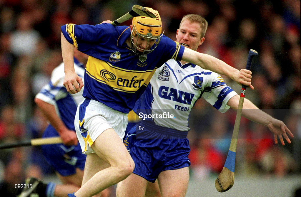 30 June 2002; Lar Corbett, Tipperary, in action against Waterford's Brian Flannery. Waterford v Tipperary, Guinness Munster Hurling Final, Pairc Ui Chaoimh, Cork. Picture credit; Ray McManus / SPORTSFILE