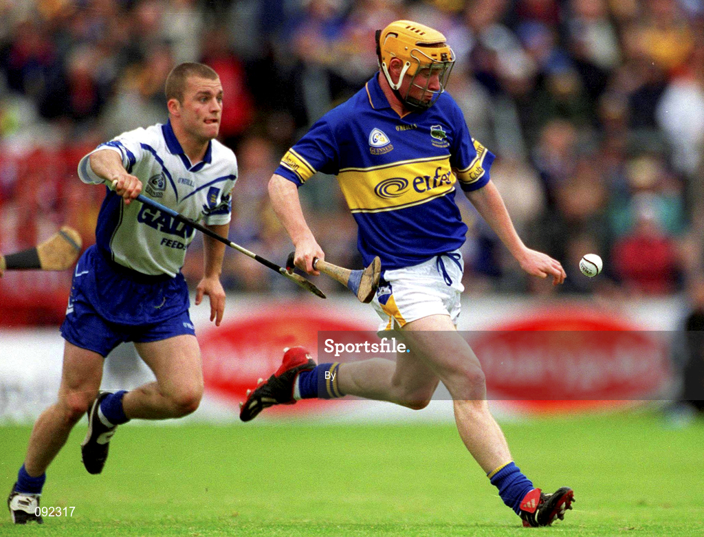 30 June 2002; Eamonn Corcoran, Tipperary, in action against Waterford's Eoin McGrath. Waterford v Tipperary, Guinness Munster Hurling Final, Pairc Ui Chaoimh, Cork. Picture credit; Ray McManus / SPORTSFILE