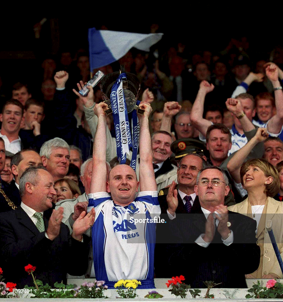 30 June 2002; Waterford captain Fergal Hartley lifts the cup in the presence of Christy Cooney, right, Chairman of the Munster Council and Michael Whelan of Guinness. Waterford v Tipperary, Guinness Munster Hurling Final, Pairc Ui Chaoimh, Cork. Picture credit; Ray McManus / SPORTSFILE