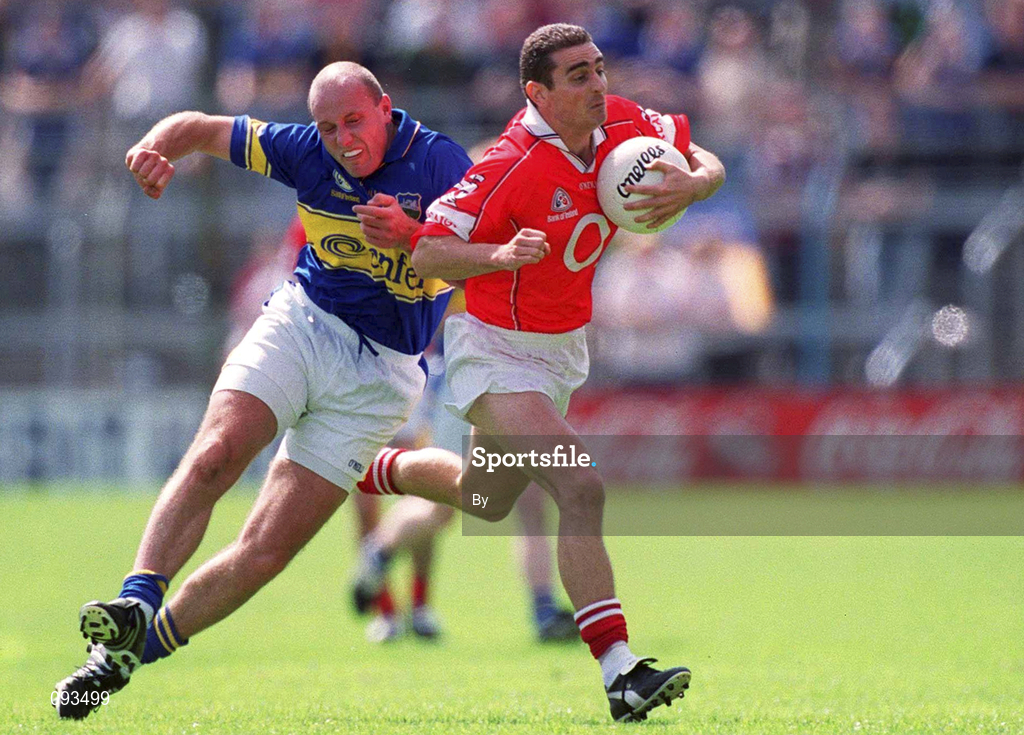 14 July 2002; Colin Crowley, Cork, is tackled by Tipperary's Sean Collum. Cork v Tipperary, Bank of Ireland Munster Senior Football Final, Semple Stadium, Thurles, Co. Tipperary. Picture credit; Brendan Moran / SPORTSFILE