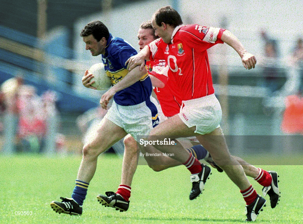 14 July 2002; Brendan Cummins of Tipperary, is tackled by Ronan McCarthy of Cork during the Bank of Ireland Munster Senior Football Final match between Tipperary and Cork at Semple Stadium in Thurles, Tipperary. Photo by Brendan Moran/Sportsfile