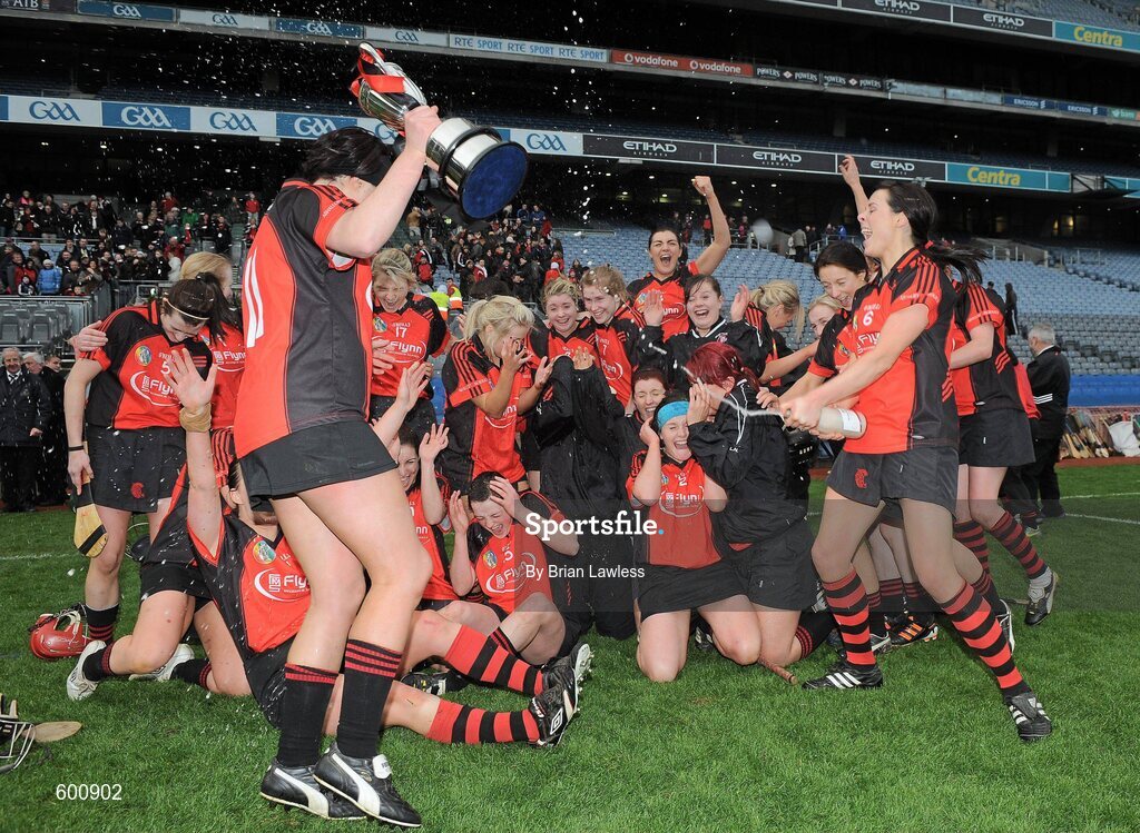 4 March 2012; Oulart-the-Ballagh captain Una Leacy arrives with the cup as team-mate and sister Mary Leacy, right, celebrates. All Ireland Senior Camogie Club Championship Final 2011, Drom/Inch, Tipperary v Oulart-the-Ballagh, Wexford, Croke Park, Dublin. Picture credit: Brian Lawless / SPORTSFILE
