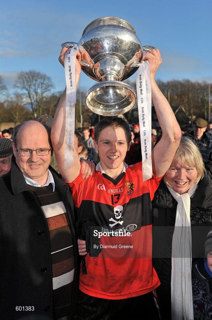 3 March 2012; UCC captain Shane Bourke lifts the cup, alongside his father Paddy, left, and his mother Teresa, after victory over CIT. Irish Daily Mail Fitzgibbon Cup Final, University College Cork v Cork Institute of Technology, Mardyke Arena, Cork. Picture credit: Diarmuid Greene / SPORTSFILE