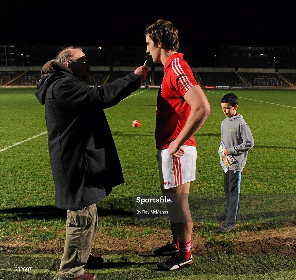 10 March 2012; Eleven year old Cork supporter and autograph hunter Adam Kerfali, from Graigcullen, Co Laois, waits as Aidan Walsh is interviewed by journalist Noel Horgan. Allianz Football League, Division 1, Round 4, Laois v Cork, O'Moore Park, Portlaoise, Co. Laois. Picture credit: Ray McManus / SPORTSFILE