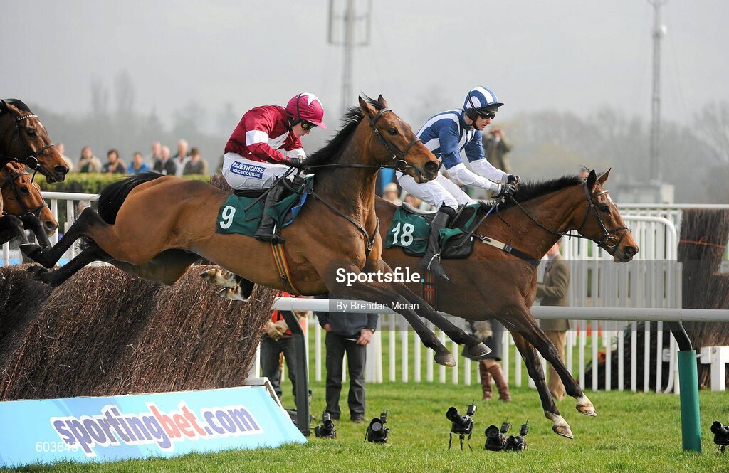 14 March 2012; Teaforthree, with John Thomas McNamara up, right, leads eventual third place Four Commanders, with Nina Carberry up, over the last, first time round, on their way to winning the Diamond Jubilee National Hunt Steeple Chase. Cheltenham Racing Festival, Prestbury Park, Cheltenham, England. Picture credit: Brendan Moran / SPORTSFILE