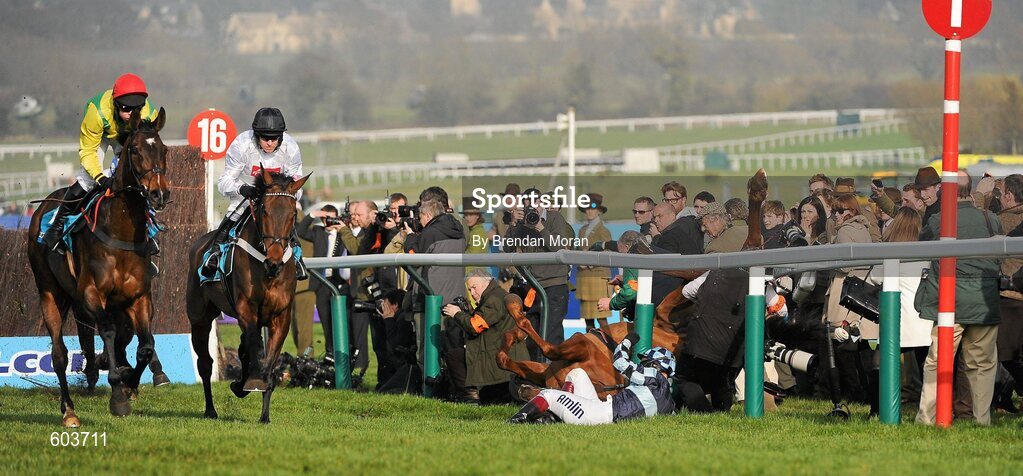 14 March 2012; Jockey Richard Johnson is unseated by his mount Wishful Thinking as they crash into a number of photographers and trackside personnel as the eventual winner Finian's Rainbow, right, with Barry Geraghty up, and eventual second Sizing Europe, Andrew Lynch up, clear 'the last first time round' during the sportingbet.com Queen Mother Champion Steeple Chase. Cheltenham Racing Festival, Prestbury Park, Cheltenham, England. Picture credit: Brendan Moran / SPORTSFILE