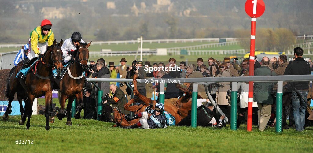 14 March 2012; Jockey Richard Johnson is unseated by his mount Wishful Thinking as they crash into a number of photographers and trackside personnel as eventual second Sizing Europe, Andrew Lynch up, left, leads eventual winner Finian's Rainbow, with Barry Geraghty up, after clearing 'the last first time round' during the sportingbet.com Queen Mother Champion Steeple Chase. Cheltenham Racing Festival, Prestbury Park, Cheltenham, England. Picture credit: Brendan Moran / SPORTSFILE
