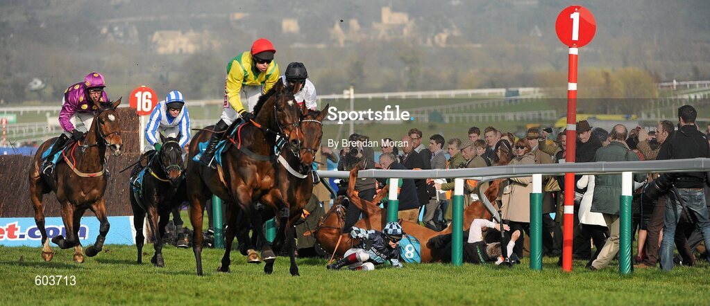 14 March 2012; Jockey Richard Johnson is unseated by his mount Wishful Thinking as they crash into a number of photographers and trackside personnel as eventual second Sizing Europe, Andrew Lynch up, left, leads eventual winner Finian's Rainbow, with Barry Geraghty up, after clearing 'the last first time round' during the sportingbet.com Queen Mother Champion Steeple Chase. Cheltenham Racing Festival, Prestbury Park, Cheltenham, England. Picture credit: Brendan Moran / SPORTSFILE
