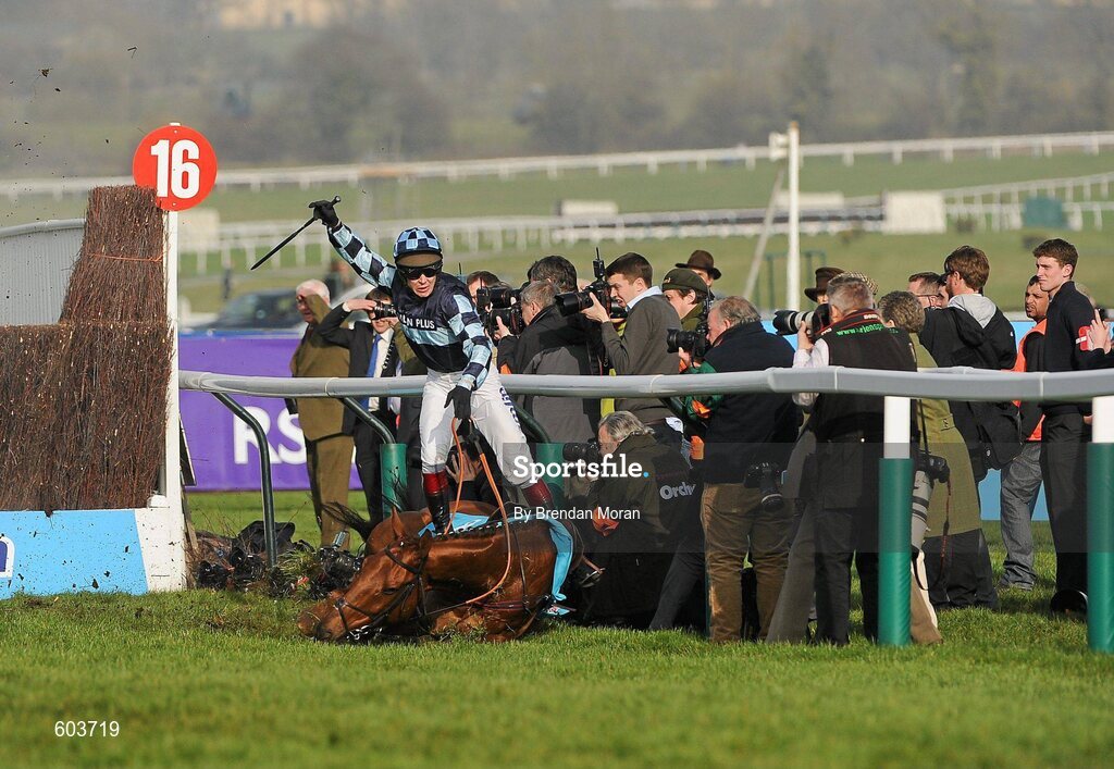 14 March 2012; Jockey Richard Johnson is unseated by his mount Wishful Thinking as they crash into a number of photographers and trackside personnel after they had jumped the 'last first time round' during the sportingbet.com Queen Mother Champion Steeple Chase. Cheltenham Racing Festival, Prestbury Park, Cheltenham, England. Picture credit: Brendan Moran / SPORTSFILE
