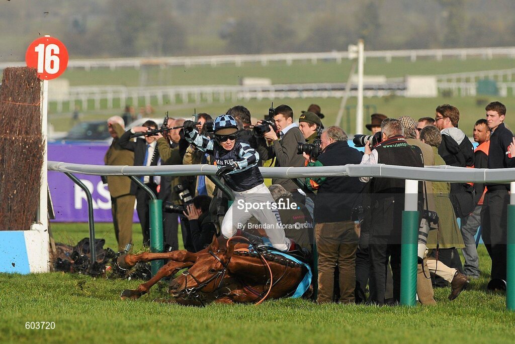 14 March 2012; Jockey Richard Johnson is unseated by his mount Wishful Thinking as they crash into a number of photographers and trackside personnel after they had jumped the 'last first time round' during the sportingbet.com Queen Mother Champion Steeple Chase. Cheltenham Racing Festival, Prestbury Park, Cheltenham, England. Picture credit: Brendan Moran / SPORTSFILE