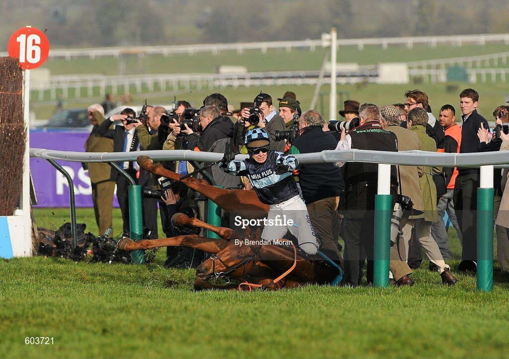14 March 2012; Jockey Richard Johnson is unseated by his mount Wishful Thinking as they crash into a number of photographers and trackside personnel after they had jumped the 'last first time round' during the sportingbet.com Queen Mother Champion Steeple Chase. Cheltenham Racing Festival, Prestbury Park, Cheltenham, England. Picture credit: Brendan Moran / SPORTSFILE