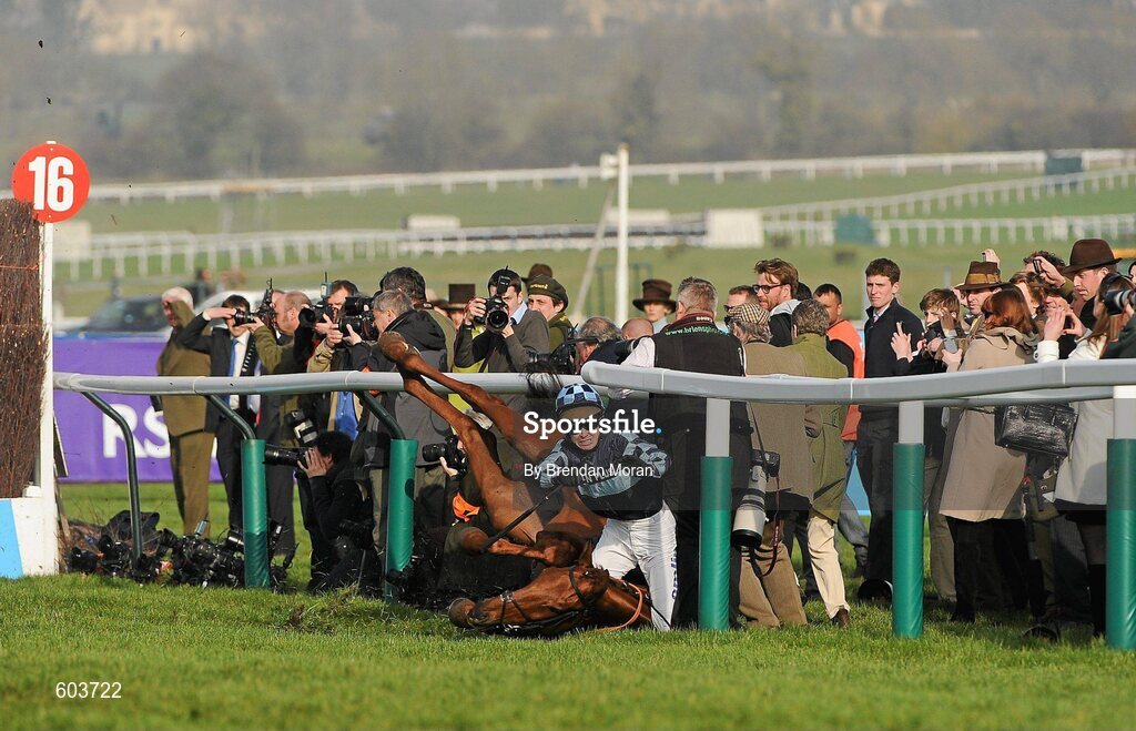 14 March 2012; Jockey Richard Johnson is unseated by his mount Wishful Thinking as they crash into a number of photographers and trackside personnel after they had jumped the 'last first time round' during the sportingbet.com Queen Mother Champion Steeple Chase. Cheltenham Racing Festival, Prestbury Park, Cheltenham, England. Picture credit: Brendan Moran / SPORTSFILE