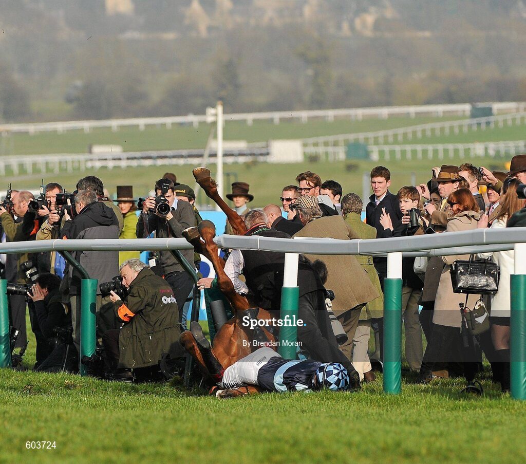 14 March 2012; Jockey Richard Johnson is unseated by his mount Wishful Thinking as they crash into a number of photographers and trackside personnel after they had jumped the 'last first time round' during the sportingbet.com Queen Mother Champion Steeple Chase. Cheltenham Racing Festival, Prestbury Park, Cheltenham, England. Picture credit: Brendan Moran / SPORTSFILE