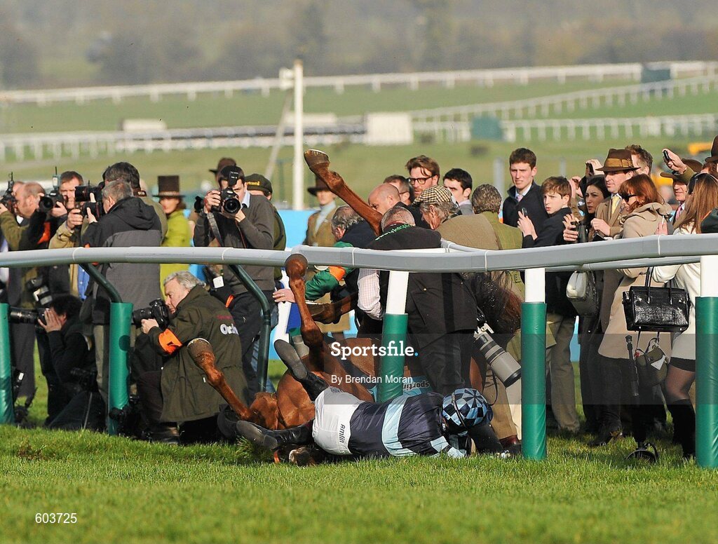 14 March 2012; Jockey Richard Johnson is unseated by his mount Wishful Thinking as they crash into a number of photographers and trackside personnel after they had jumped the 'last first time round' during the sportingbet.com Queen Mother Champion Steeple Chase. Cheltenham Racing Festival, Prestbury Park, Cheltenham, England. Picture credit: Brendan Moran / SPORTSFILE