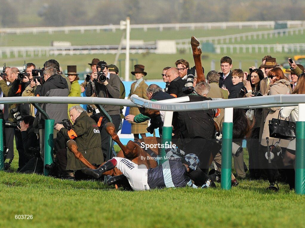 14 March 2012; Jockey Richard Johnson is unseated by his mount Wishful Thinking as they crash into a number of photographers and trackside personnel after they had jumped the 'last first time round' during the sportingbet.com Queen Mother Champion Steeple Chase. Cheltenham Racing Festival, Prestbury Park, Cheltenham, England. Picture credit: Brendan Moran / SPORTSFILE