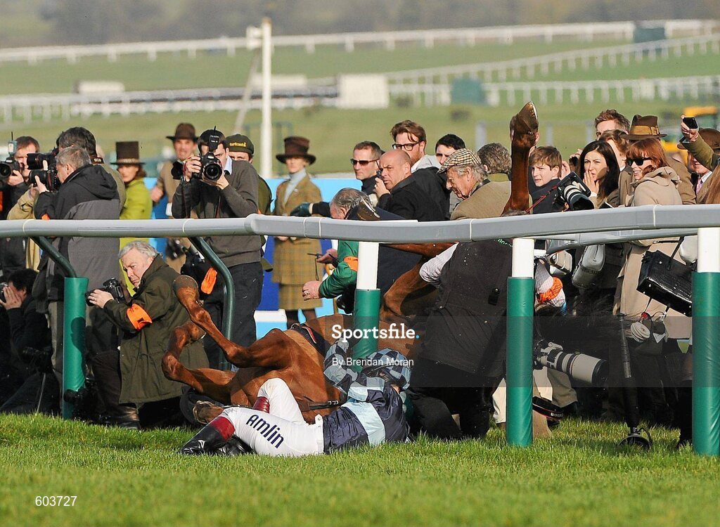14 March 2012; Jockey Richard Johnson is unseated by his mount Wishful Thinking as they crash into a number of photographers and trackside personnel after they had jumped the 'last first time round' during the sportingbet.com Queen Mother Champion Steeple Chase. Cheltenham Racing Festival, Prestbury Park, Cheltenham, England. Picture credit: Brendan Moran / SPORTSFILE