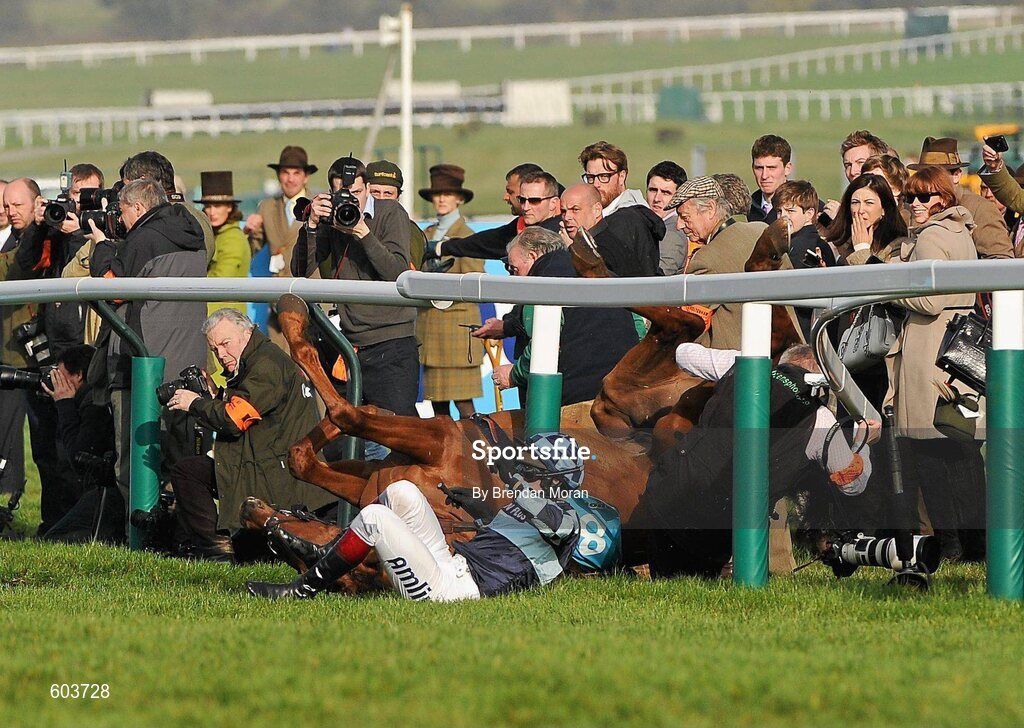 14 March 2012; Jockey Richard Johnson is unseated by his mount Wishful Thinking as they crash into a number of photographers and trackside personnel after they had jumped the 'last first time round' during the sportingbet.com Queen Mother Champion Steeple Chase. Cheltenham Racing Festival, Prestbury Park, Cheltenham, England. Picture credit: Brendan Moran / SPORTSFILE