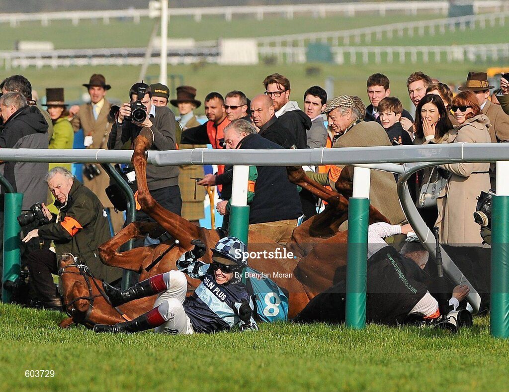 14 March 2012; Jockey Richard Johnson is unseated by his mount Wishful Thinking as they crash into a number of photographers and trackside personnel after they had jumped the 'last first time round' during the sportingbet.com Queen Mother Champion Steeple Chase. Cheltenham Racing Festival, Prestbury Park, Cheltenham, England. Picture credit: Brendan Moran / SPORTSFILE