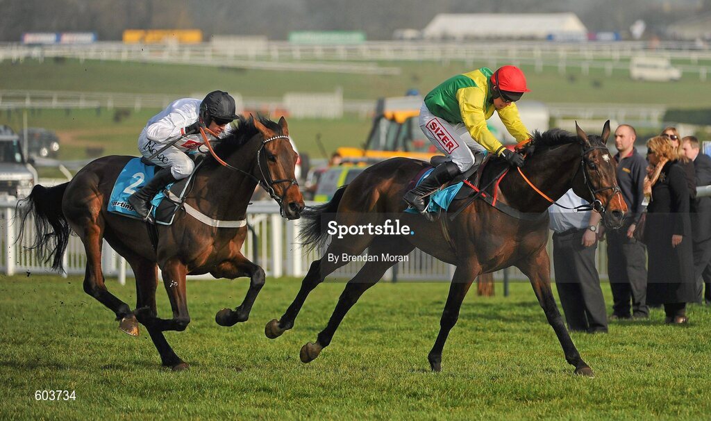 14 March 2012; Sizing Europe, with Andrew Lynch up, leads eventual winner Finian's Rainbow, with Barry Geraghty up, left, as they bypass what was to be the last during the sportingbet.com Queen Mother Champion Steeple Chase. Cheltenham Racing Festival, Prestbury Park, Cheltenham, England. Picture credit: Brendan Moran / SPORTSFILE