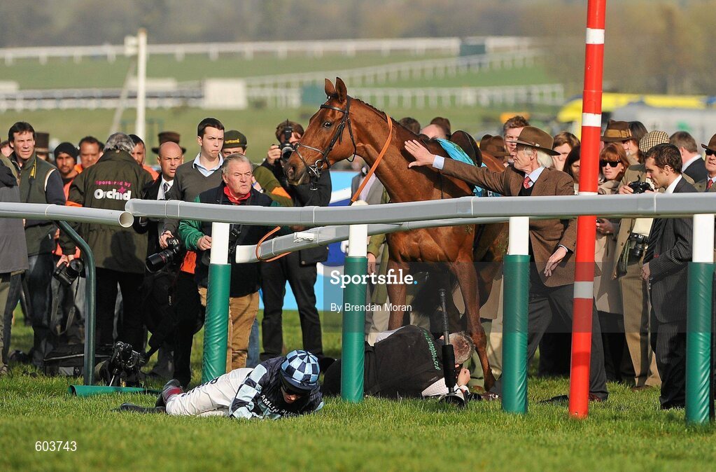 14 March 2012; Jockey Richard Johnson is unseated by his mount Wishful Thinking as they crash into a number of photographers and trackside personnel after they had jumped the 'last first time round' during the sportingbet.com Queen Mother Champion Steeple Chase. Cheltenham Racing Festival, Prestbury Park, Cheltenham, England. Picture credit: Brendan Moran / SPORTSFILE