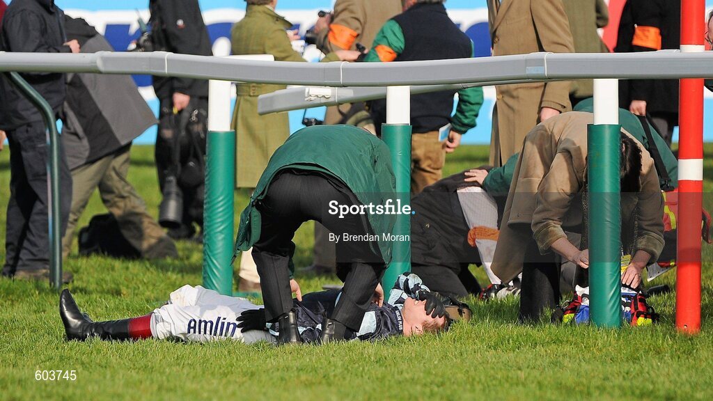 14 March 2012; Jockey Richard Johnson after he was unseated by his mount Wishful Thinking and crashed into a number of photographers and trackside personnel after they had jumped the 'last first time round' during the sportingbet.com Queen Mother Champion Steeple Chase. Cheltenham Racing Festival, Prestbury Park, Cheltenham, England. Picture credit: Brendan Moran / SPORTSFILE
