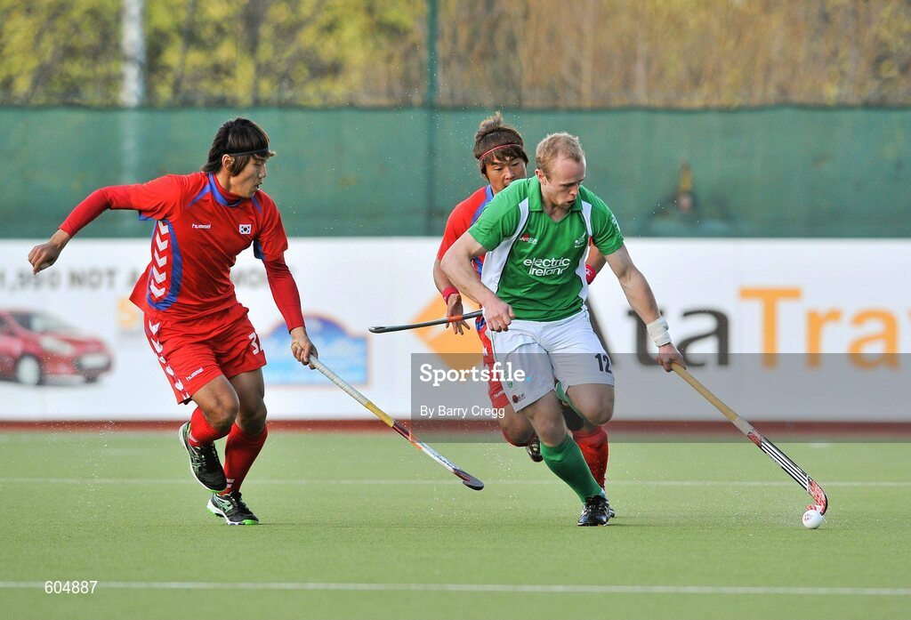 18 March 2012; Eugene Magee, Ireland, in action against Dae Keun Oh, left, and Hyun Woo Nam, far left, Korea. Men’s 2012 Olympic Qualifying Tournament Final, Ireland v Korea. National Hockey Stadium, UCD, Belfield, Dublin. Picture credit: Barry Cregg / SPORTSFILE