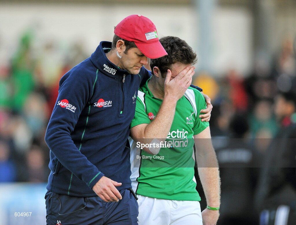 18 March 2012; A dejected John Jackson, Ireland, is comforted by team manager Paul Revington after the game. Men’s 2012 Olympic Qualifying Tournament Final, Ireland v Korea. National Hockey Stadium, UCD, Belfield, Dublin. Picture credit: Barry Cregg / SPORTSFILE