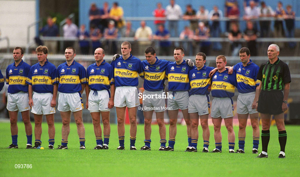 14 July 2002; The Tipperary team stand together for the National Anthem alongside referee Gerry Kinneavy before the Bank of Ireland Munster Senior Football Championship Final match between Cork and Tipperary at Semple Stadium in Thurles, Tipperary. Photo by Brendan Moran/Sportsfile