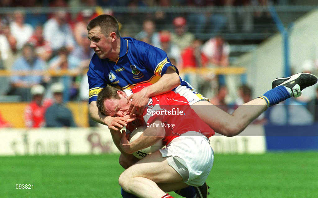 14 July 2002; Philip Clifford of Cork in action against Niall Fitzgerald of Tipperary during the Bank of Ireland Munster Senior Football Championship Final match between Cork and Tipperary at Semple Stadium in Thurles, Tipperary. Photo by Pat Murphy/Sportsfile