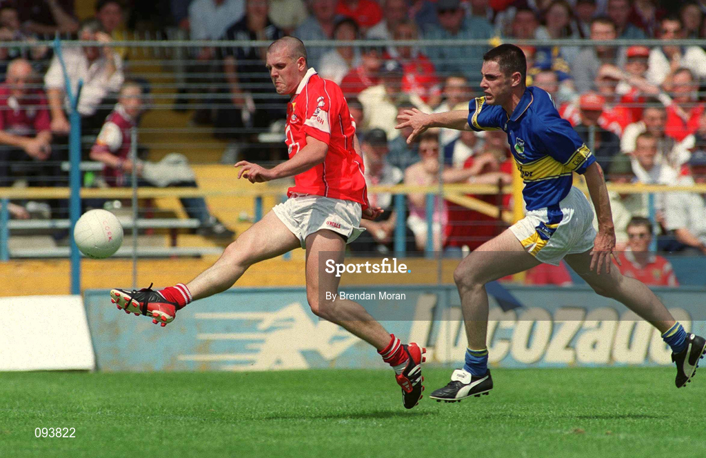 14 July 2002; Brendan Ger O'Sullivan of Cork scores his and side's second goal despite Niall Fitzgerald of Tipperary during the Bank of Ireland Munster Senior Football Championship Final match between Cork and Tipperary at Semple Stadium in Thurles, Tipperary. Photo by Brendan Moran/Sportsfile