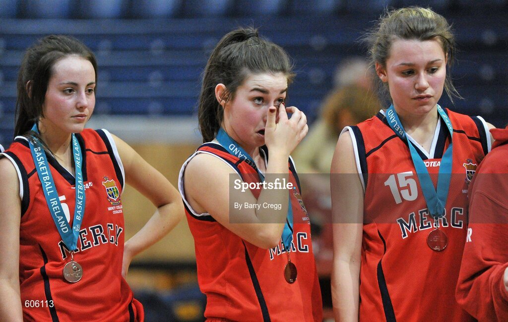 22 March 2012; A dejected Antonia Cummins, centre, Mercy Coolock, wipes away her tears alongside team-mates Lynn Ryan, left, and Sarah Fitzpatrick after the game. U16B Girls - All-Ireland Schools League Finals 2012, Mercy Coolock, Dublin v Christ the King, Cork, National Basketball Arena, Tallaght, Dublin. Picture credit: Barry Cregg / SPORTSFILE
