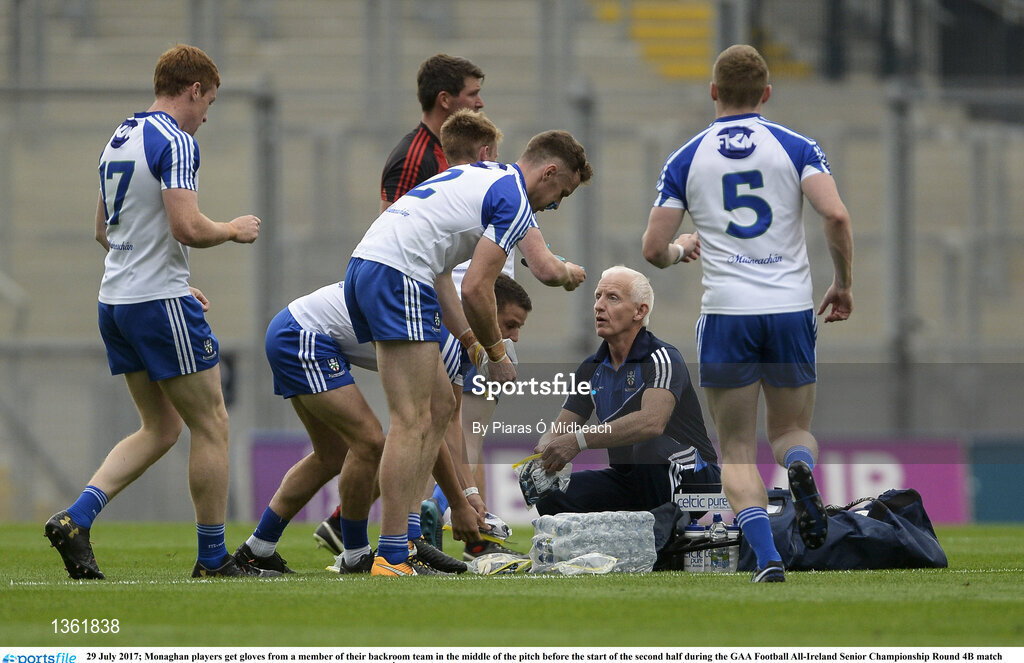 29 July 2017; Monaghan players get gloves from a member of their backroom team in the middle of the pitch before the start of the second half during the GAA Football All-Ireland Senior Championship Round 4B match between Down and Monaghan at Croke Park in Dublin. Photo by Piaras Ó Mídheach/Sportsfile