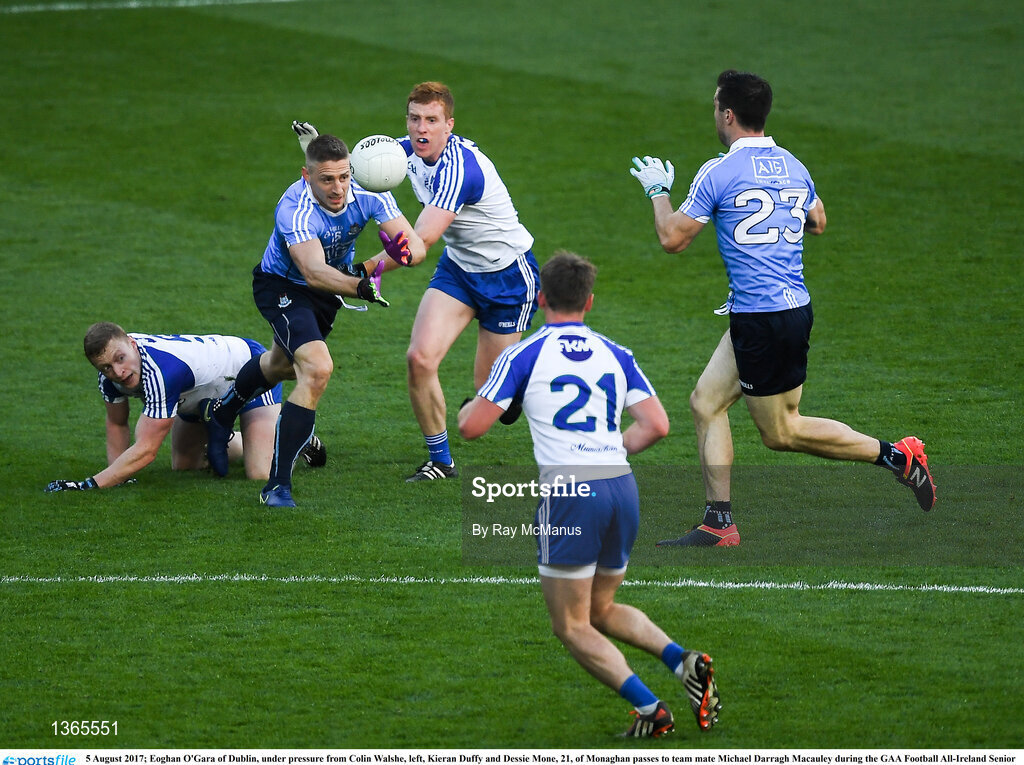 5 August 2017; Eoghan O'Gara of Dublin, under pressure from Colin Walshe, left, Kieran Duffy and Dessie Mone, 21, of Monaghan passes to team mate Michael Darragh Macauley during the GAA Football All-Ireland Senior Championship Quarter-Final match between Dublin and Monaghan at Croke Park in Dublin. Photo by Ray McManus/Sportsfile