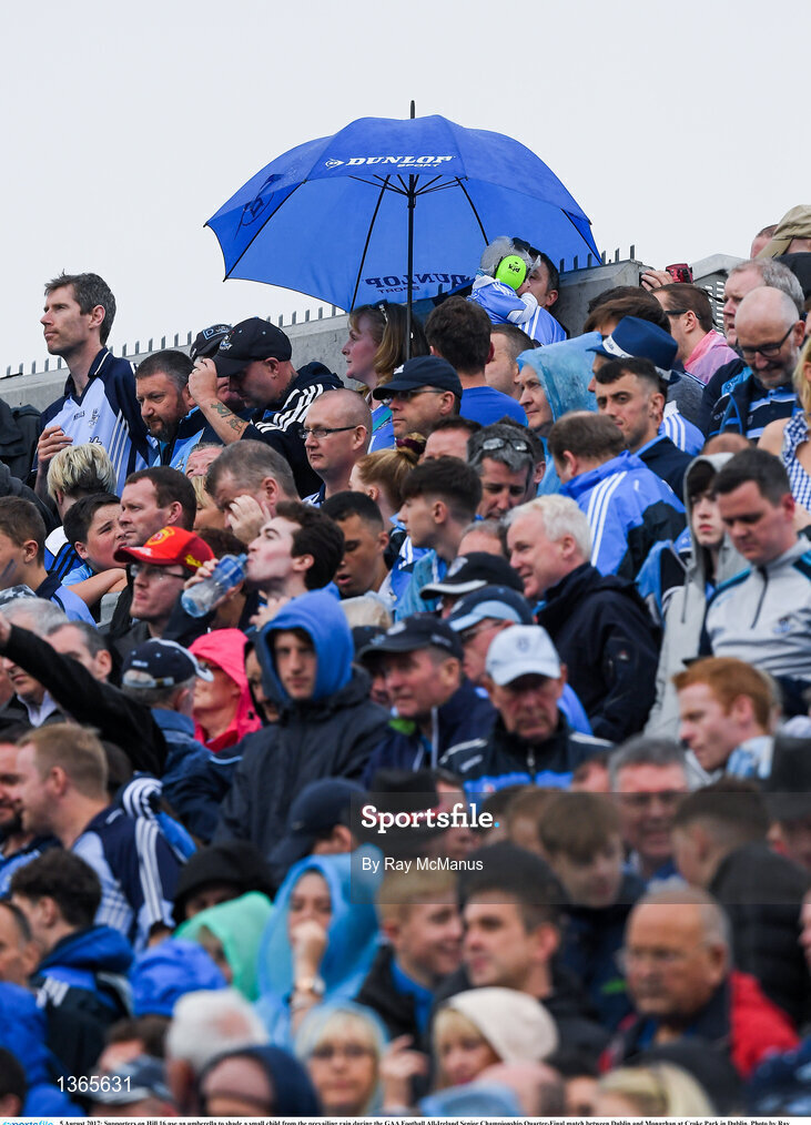 5 August 2017; Supporters on Hill 16 use an umberella to shade a small child from the prevailing rain during the GAA Football All-Ireland Senior Championship Quarter-Final match between Dublin and Monaghan at Croke Park in Dublin. Photo by Ray McManus/Sportsfile