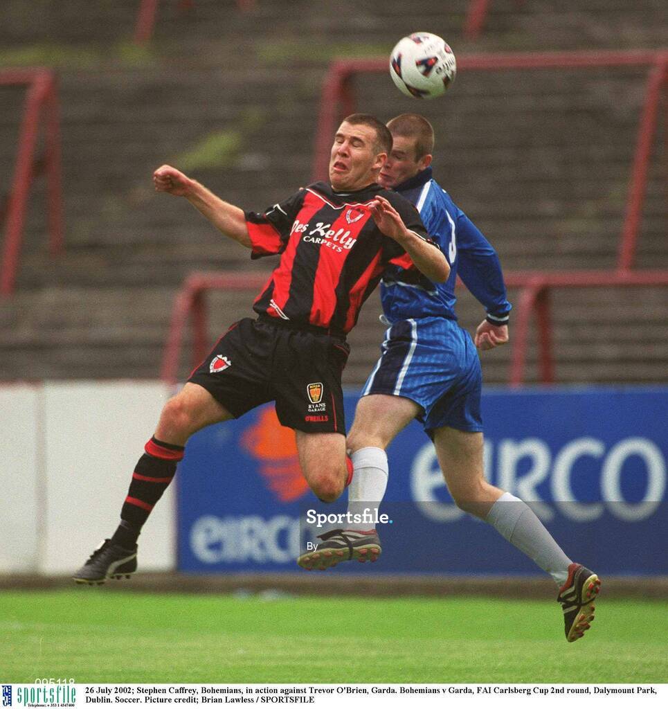 26 July 2002; Stephen Caffrey, Bohemians, in action against Trevor O'Brien, Garda. Bohemians v Garda, FAI Carlsberg Cup 2nd round, Dalymount Park, Dublin. Soccer. Picture credit; Brian Lawless / SPORTSFILE