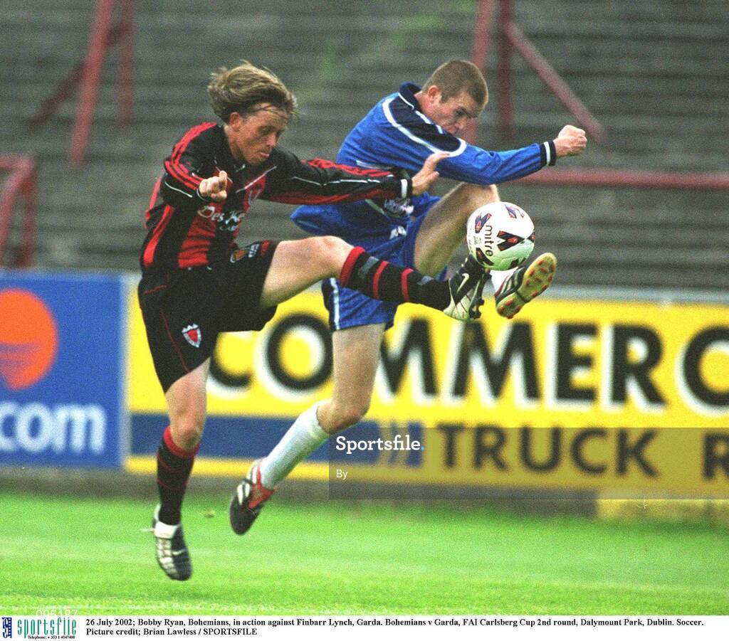 26 July 2002; Bobby Ryan, Bohemians, in action against Finbarr Lynch, Garda. Bohemians v Garda, FAI Carlsberg Cup 2nd round, Dalymount Park, Dublin. Soccer. Picture credit; Brian Lawless / SPORTSFILE
